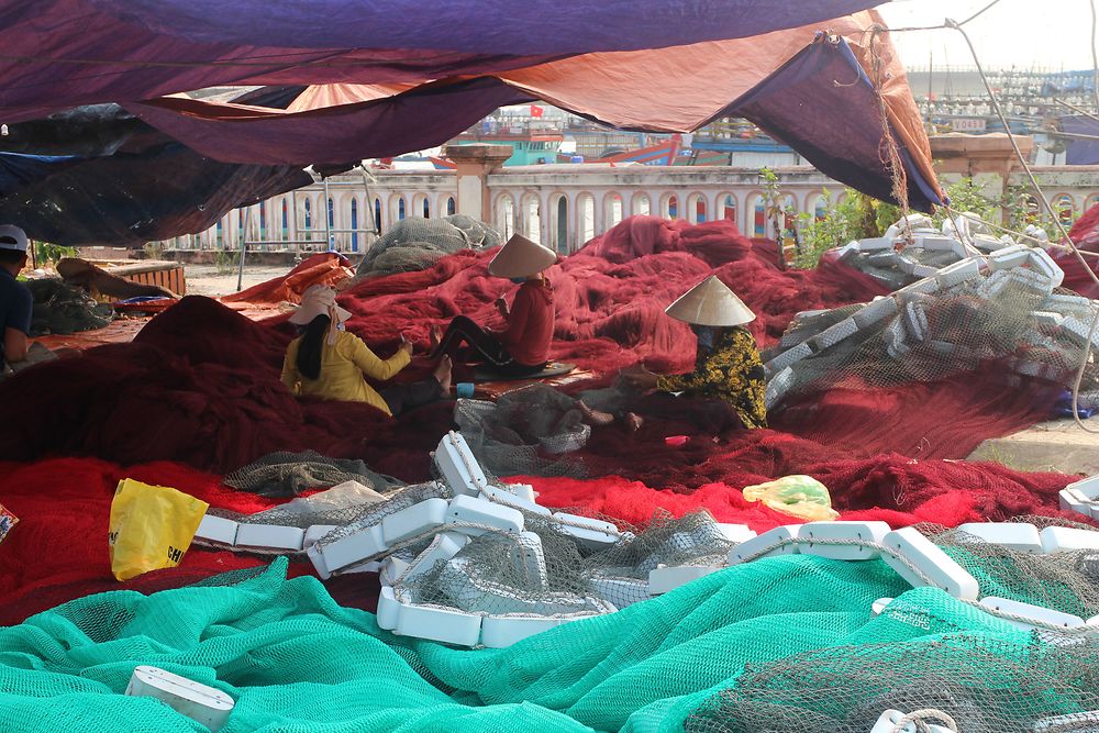 Des femmes réparent des filets de pêche à Dong Hoi